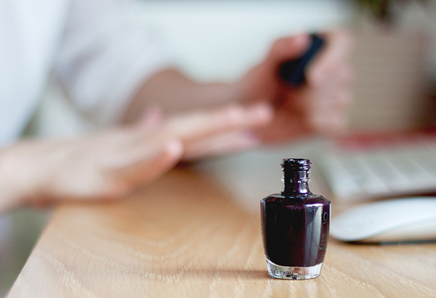 Woman applying nail polish